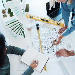 Architect, paper and blueprint with meeting, planning and woman with model, book or writing. Buildi.