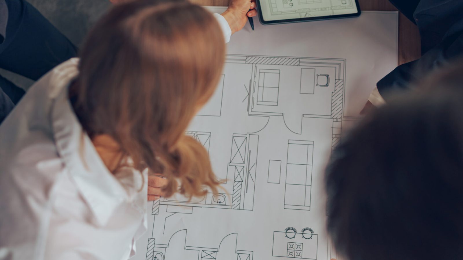 Group of professional team design engineers working with project documents in modern office