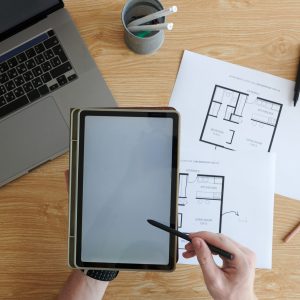 Hands of young man drawing apartment design project on tablet computer